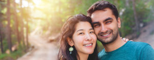 A young couple smiling outdoors