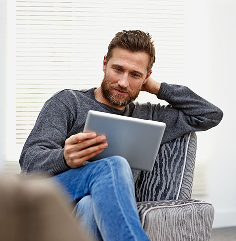 a man reading a tablet device