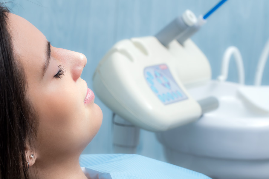 Female patient relaxing in the dental chair due to dental sedation.