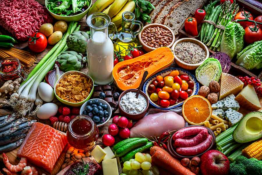 Colorful photo showing a wide variety of fruits, vegetables, meats & grains for a balanced diet.