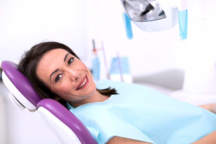 Brunette woman in the  dental chair for a root canal.